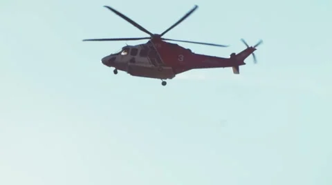 Helicopter flying across sun Stock-Footage 54642568
