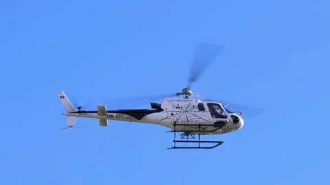 Helicopter Flying Against Blue Sky with Sunlight and Transport a Box with Wire Vídeos de archivo 221509155