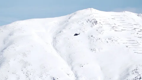 Helicopter flying against snow covered mountains in Switzerland 스톡 동영상 102066853