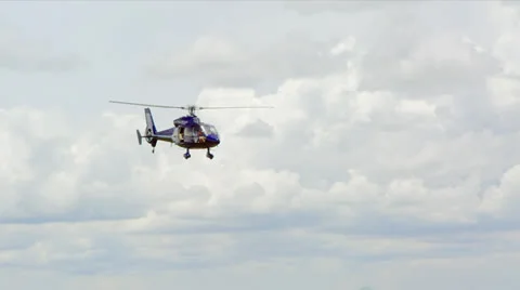 Helicopter Flying with a Background of White Clouds 스톡 동영상 25571374