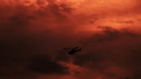Helicopter Flying in Beautiful Storm Clouds in Sunset Stock Footage 289281917