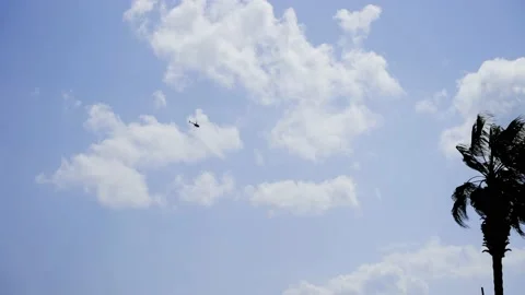 Helicopter flying below clouds - Slow Motion Stock Footage 173767485