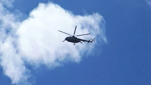 Helicopter flying in blue sky Stock Footage 78086421