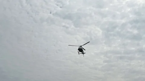 Helicopter flying in the blue sky Stock Footage 118501334