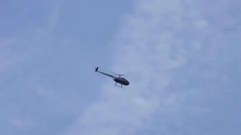 Helicopter flying in blue sky Stock Footage 201597609