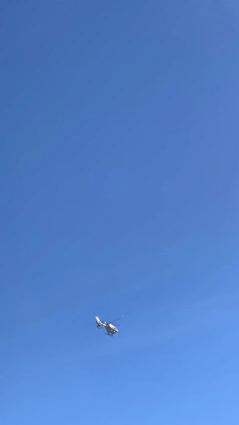 Helicopter flying in blue sky Stock Footage 337052190