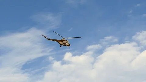 Helicopter Flying on Clear Sky Background Slow Motion Stock Footage 98482495