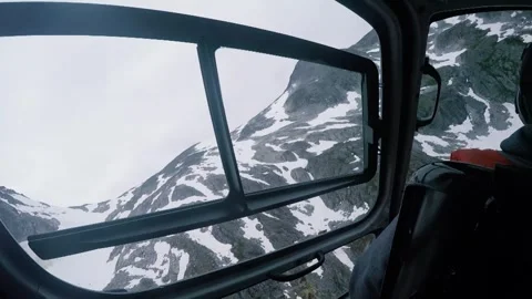 Helicopter flying close to a mountain top covered in snow in Alaska Stock Footage 287807894