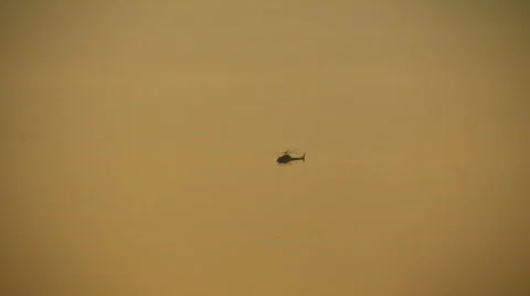 Helicopter is flying in the distance at dawn (High Definition) Stock Footage