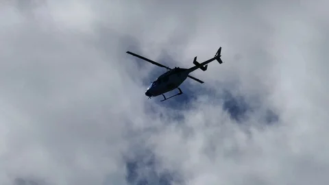 Helicopter flying in grey sky Stock Footage 95266712