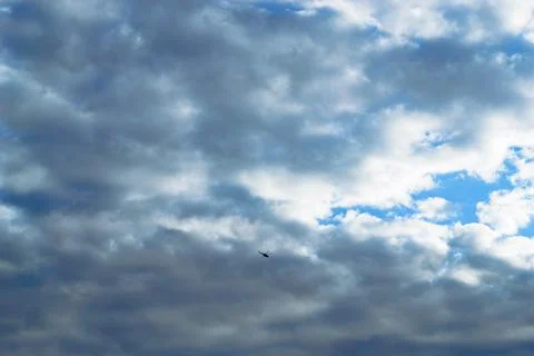 The helicopter is flying high in the sky backdrop of clouds Stock Photos