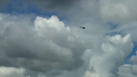 Helicopter flying high in the sky in the far distance Video stock 76208404