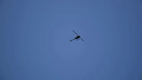 Helicopter flying at low altitude from below Stock Footage 81935499