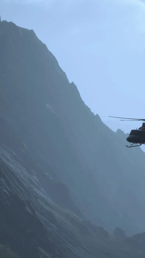 Helicopter flying near mountain range on a foggy day in nature Stockbeeldmateriaal 336248856