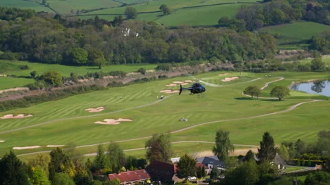 Helicopter flying over a beautiful golf course Video stock 336755432