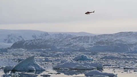 Helicopter flying over floating icebergs Video stock 113267338
