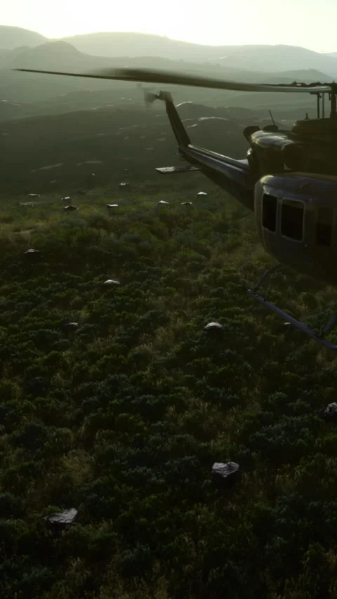 Helicopter flying over green landscape with white objects scattered below Vídeo Stock 334886810