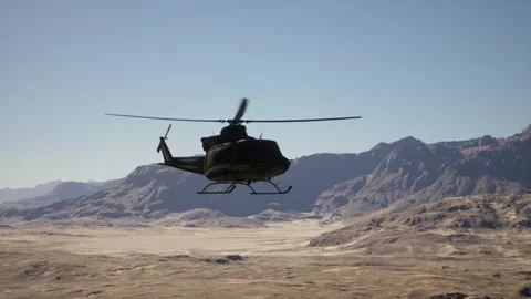 A helicopter flying over a mountain range in the desert Vídeos de archivo 255529005