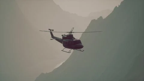 A helicopter flying over a mountain with a sky background Ilustração Stock