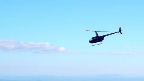 Helicopter flying over the mountains Stockbeeldmateriaal 136312052