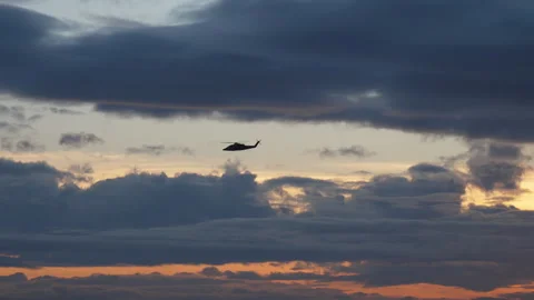 Helicopter Flying Over Ocean at Sunset  4K Stock Footage 310289639