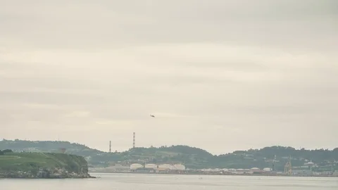 A helicopter flying over the sky of small town at cloudy rainy day Stock Footage 92690287