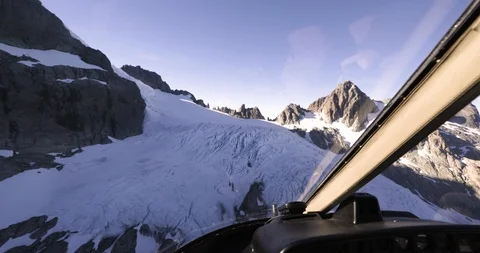 Helicopter flying over snow capped mountains in South Islands Stock Footage 93606881