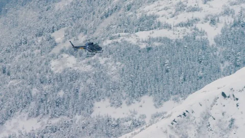 Helicopter flying over snow covered mountains Stock Footage 113254264