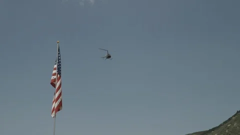 HELICOPTER FLYING PASS AMERICAN FLAG Video stock 93528069