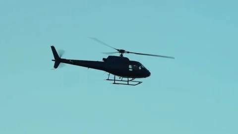 Helicopter flying in the sky at dusk Stock Footage 94331382