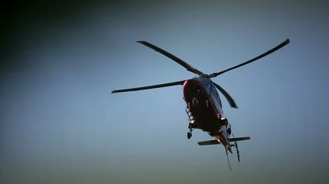 Helicopter flying in the sky tree in the foreground Stock Footage 43257504