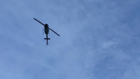 Helicopter flying in the sky. View from the ground Stock Footage 123851053