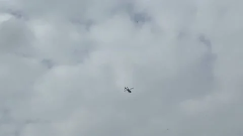 helicopter flying in the storm clouds, c... | Stock Video | Pond5