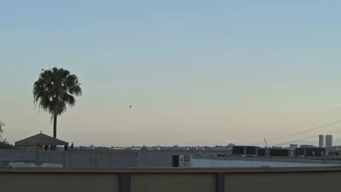 Helicopter Flying at Sunset Over Beach Town Stock Footage 131602646
