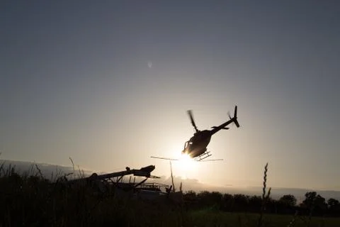 Helicopter Flying into the Sunset Stock Photos