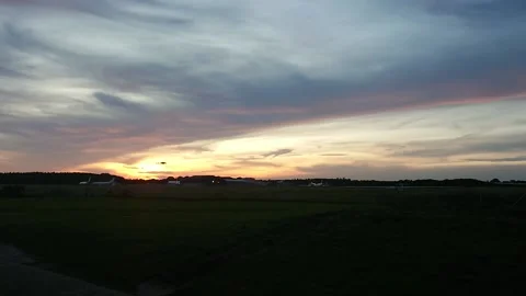 Helicopter flying through airfield during sunset Stock Footage 147550062