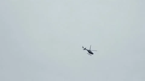 A Helicopter is Flying Through an Overcast Sky, Offering Stunning Aerial Views Vídeo Stock 295070908