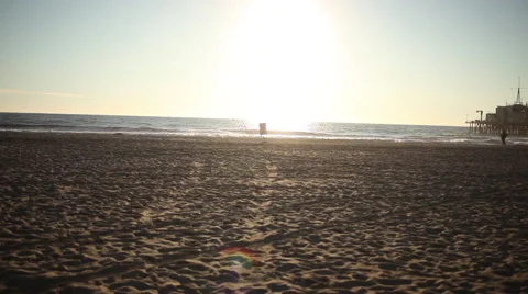 Helicopter flying through the sun on a beach Stock Footage 58635689