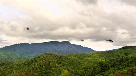 Helicopter formation over rain forest Video stock 25571383
