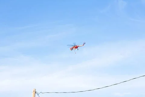 Helicopter going to Slide Fire to dump water on the flames. Stock Photos