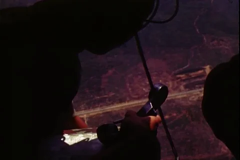 A helicopter gunner fires Machine Gun on enemy positions from helicopter - 1972 Stock Footage 106060559