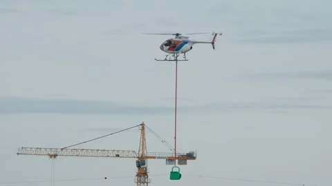 The helicopter hangs beacons on the high-voltage cable Stock Footage 153784949