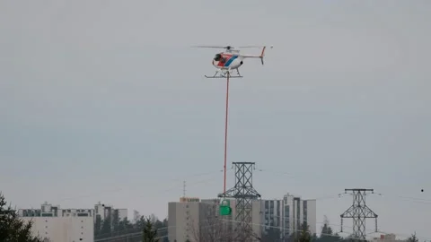 The helicopter hangs beacons on the high-voltage cable Stock Footage 153785170