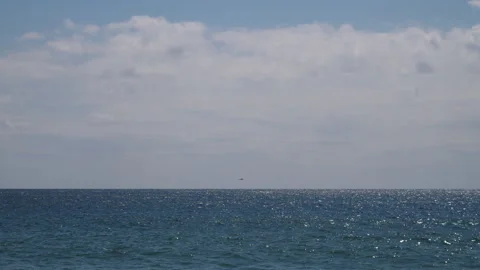 Helicopter Hover over Blue sea in distance Pt1 of 1 Stock Footage 240921598