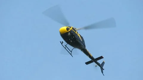 Helicopter hovering in a clear blue sky Stock Footage 170030894