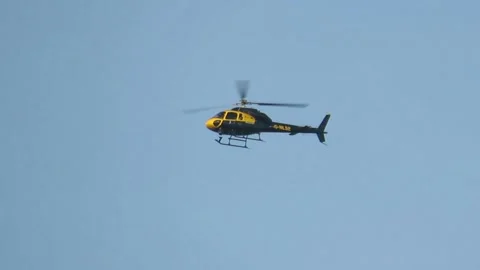 Helicopter hovering in a clear blue sky Stock Footage 293068335