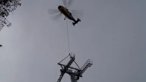 Helicopter  in hovering mode at installation of metal structures. Video stock 106607408