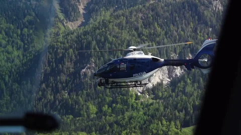 Helicopter hovering over mountain forest in slow motion Stock-Footage 71567778