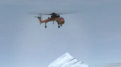 Helicopter hovering over the snow covered peak Vídeo Stock 67554240
