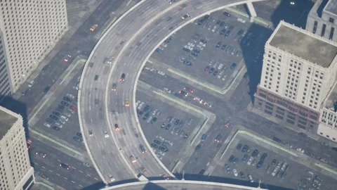A helicopter hovers over a road junction and films traffic. Stock Footage 260365024